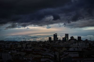 Buildings in city against sky during sunset
