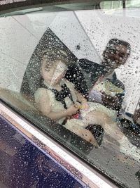 Reflection of people on wet window in rainy season
