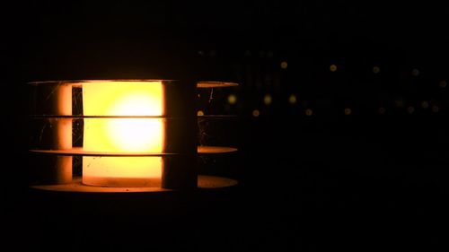 Close-up of illuminated lamp against black background