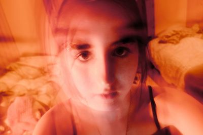 Close-up portrait of young woman at home