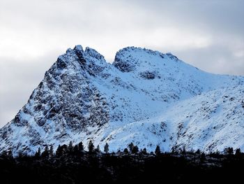 Low angle view of snowcapped mountain against sky