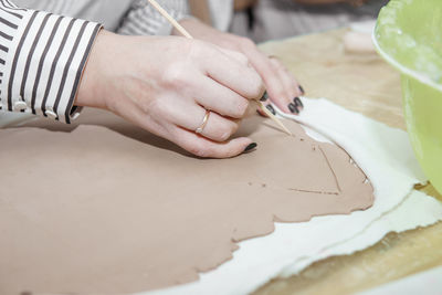 Midsection of woman working on table