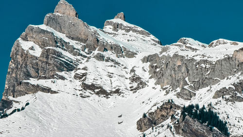 Scenic view of snowcapped mountains against clear sky