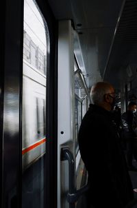 Side view of man standing at train