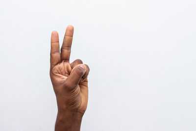 Close-up of human hand against white background