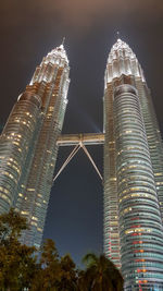 Low angle view of illuminated buildings against sky at night