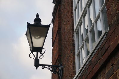 Low angle view of street light against building