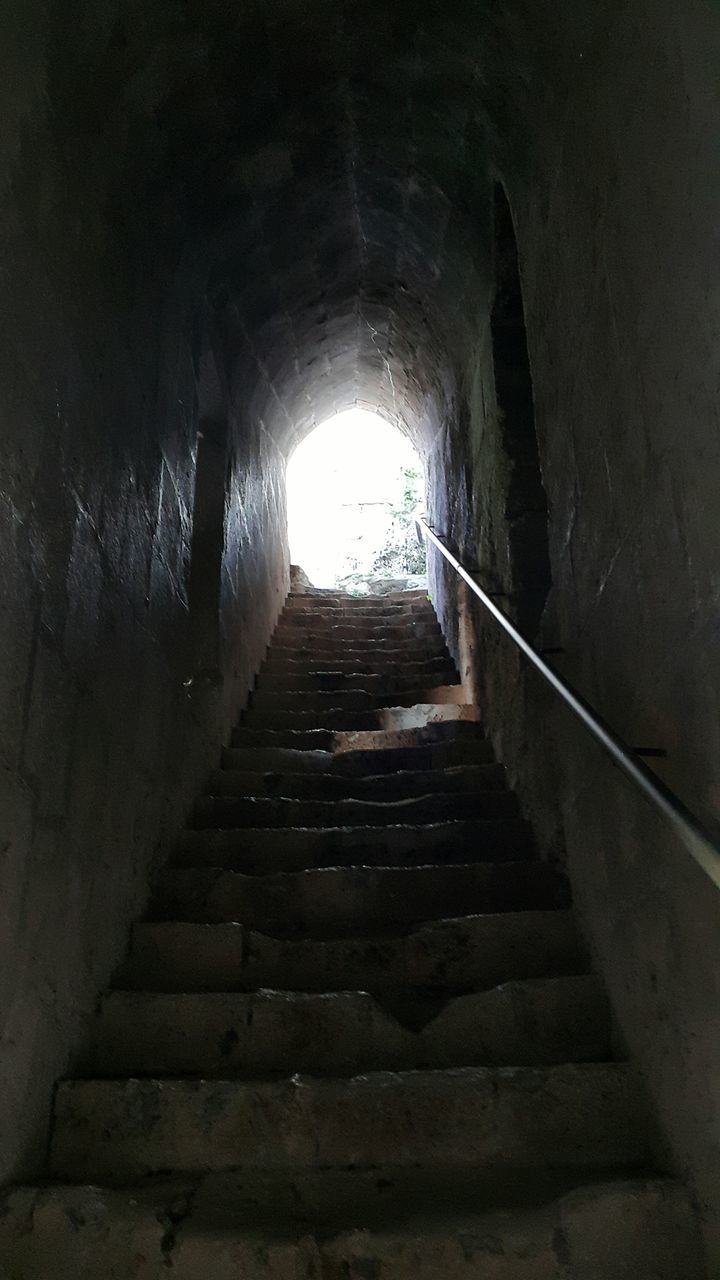 the way forward, architecture, steps, indoors, built structure, steps and staircases, staircase, tunnel, diminishing perspective, wall - building feature, arch, railing, vanishing point, old, low angle view, narrow, building, sunlight, light at the end of the tunnel, stairs