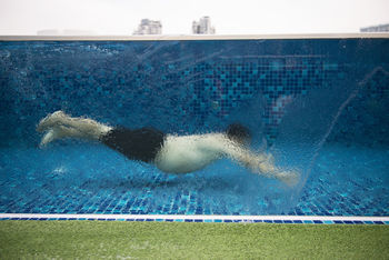 Man swimming in pool