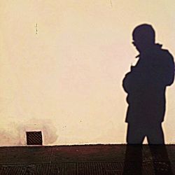 Shadow of woman standing on ground