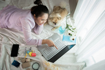 High angle view of woman using laptop on table at home