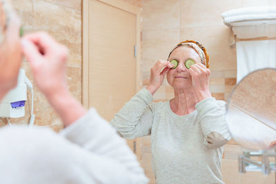 Elderly woman taking care of her face