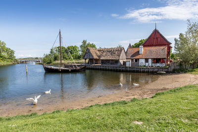 View of lake by building against sky