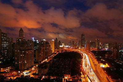 High angle view of city lit up at night