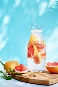 Summer cocktail with grapefruit and rosemary and juicy slices citrus fruits. 