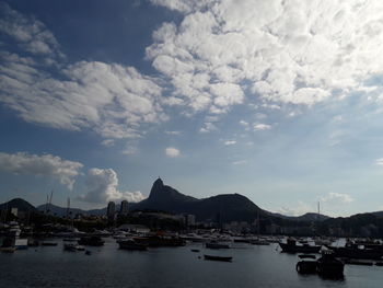 Sailboats moored in harbor