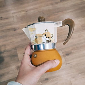 Close-up of hand holding coffee cup