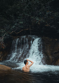 Man looking at waterfall