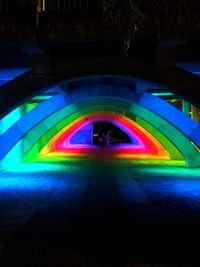 Man in illuminated tunnel