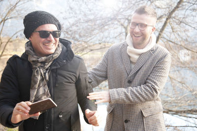 Gay couple standing outdoors in winter