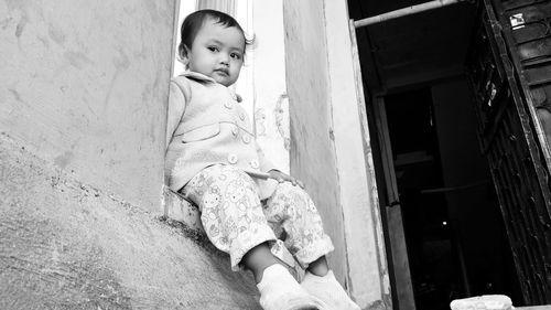 Cute girl sitting outdoors