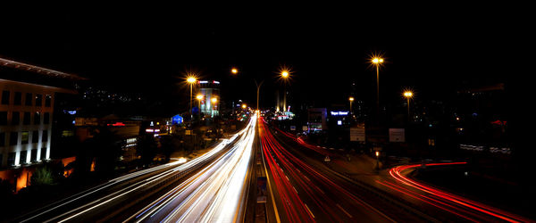 High angle view of light trails on road at night