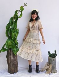 Portrait of young woman standing against plants