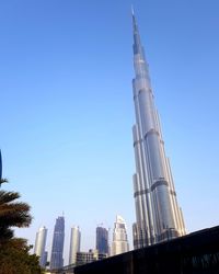 Low angle view of modern buildings against blue sky