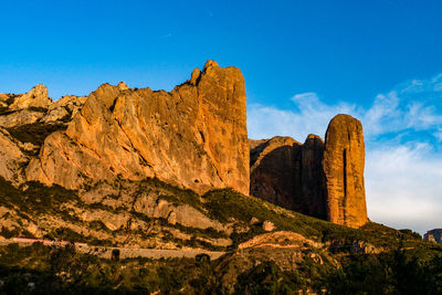 Low angle view of rock formations against sky