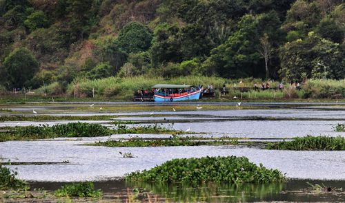 People in ferry on river