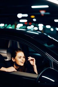 Smiling woman sitting in car