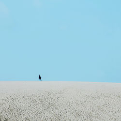 Scenic view of desert against clear blue sky