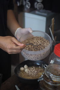 Cropped hand of person preparing food