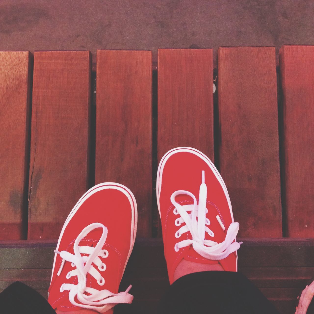 red, text, communication, western script, shoe, close-up, standing, sign, day, low section, street, wall - building feature, lifestyles, outdoors, non-western script, safety, built structure, capital letter