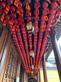 Low angle view of lanterns hanging on ceiling of building