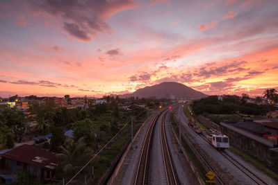 High angle view of railroad tracks against sky during sunset