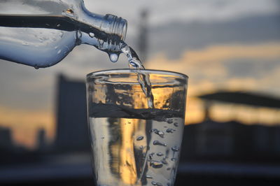 Close-up of glass pouring water