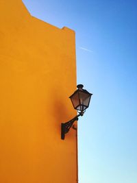 Low angle view of illuminated lamp against clear sky