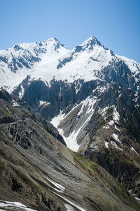 Scenic view of snowcapped mountains against clear sky