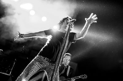 Low angle view of illuminated ferris wheel at night