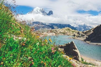 Scenic view of sea and mountains against sky