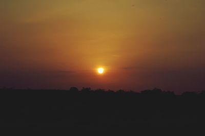 Scenic view of silhouette landscape against romantic sky at sunset