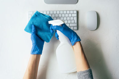 Low section of person working against blue wall at home