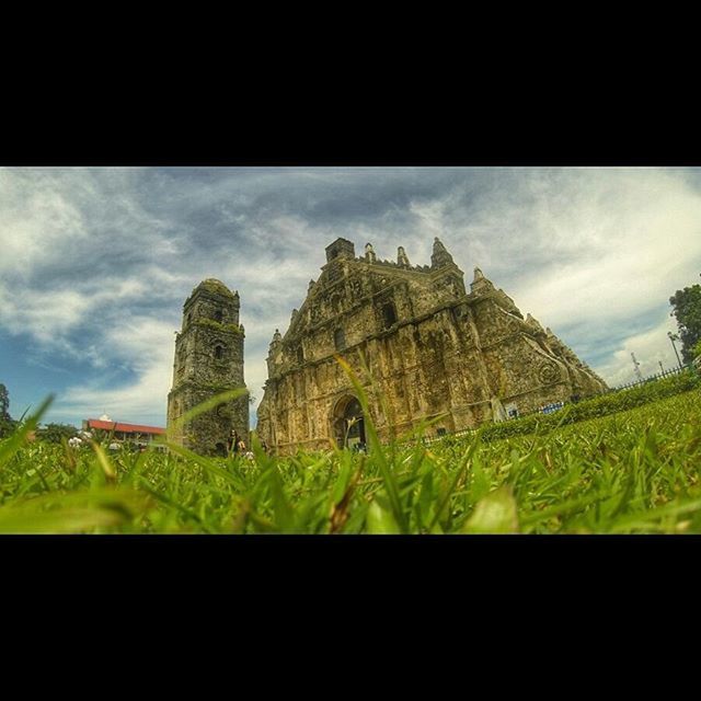 architecture, built structure, sky, building exterior, cloud - sky, history, grass, cloud, place of worship, cloudy, field, famous place, religion, castle, the past, travel destinations, green color, spirituality, ancient, old ruin