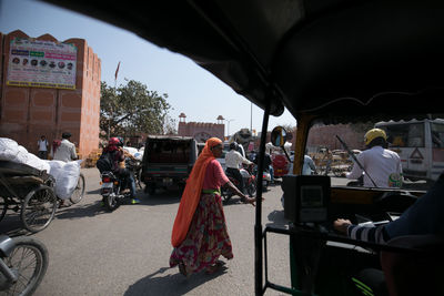 People sitting on street in city