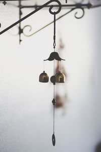 Low angle view of electric lamp hanging on ceiling