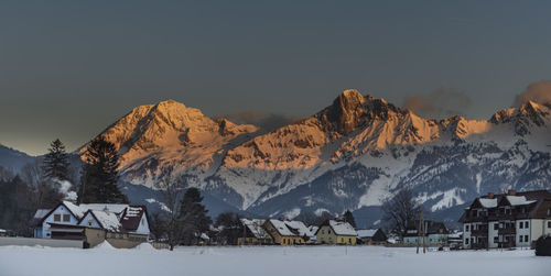 Scenic view of snowcapped mountains against sky during sunset