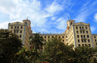 Low angle view of building against cloudy sky