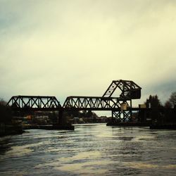 Bridge over river with buildings in background