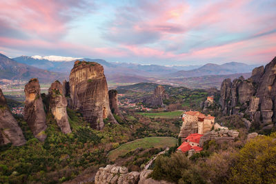 Panoramic view of rock formations on landscape against cloudy sky